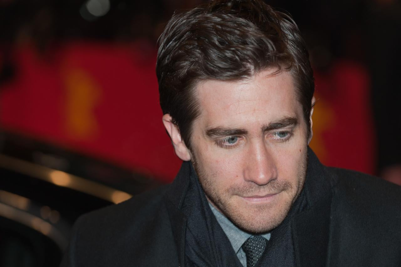 Close up shot of Jake Gyllenhaal in a black suit.